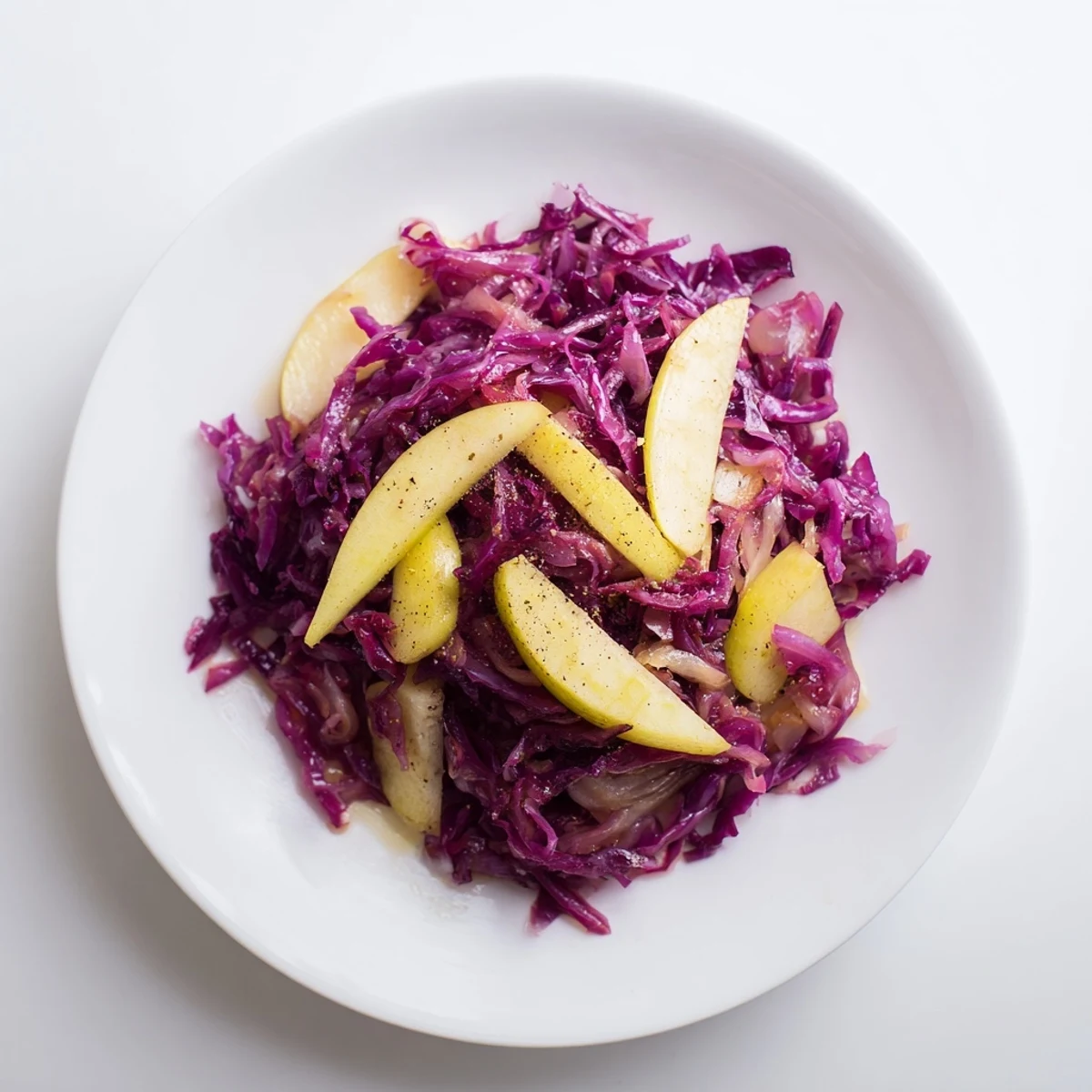 Sweet & Sour Bavarian Red Cabbage and Apple Side: A vibrant, tender dish with bright red cabbage and sliced apples.