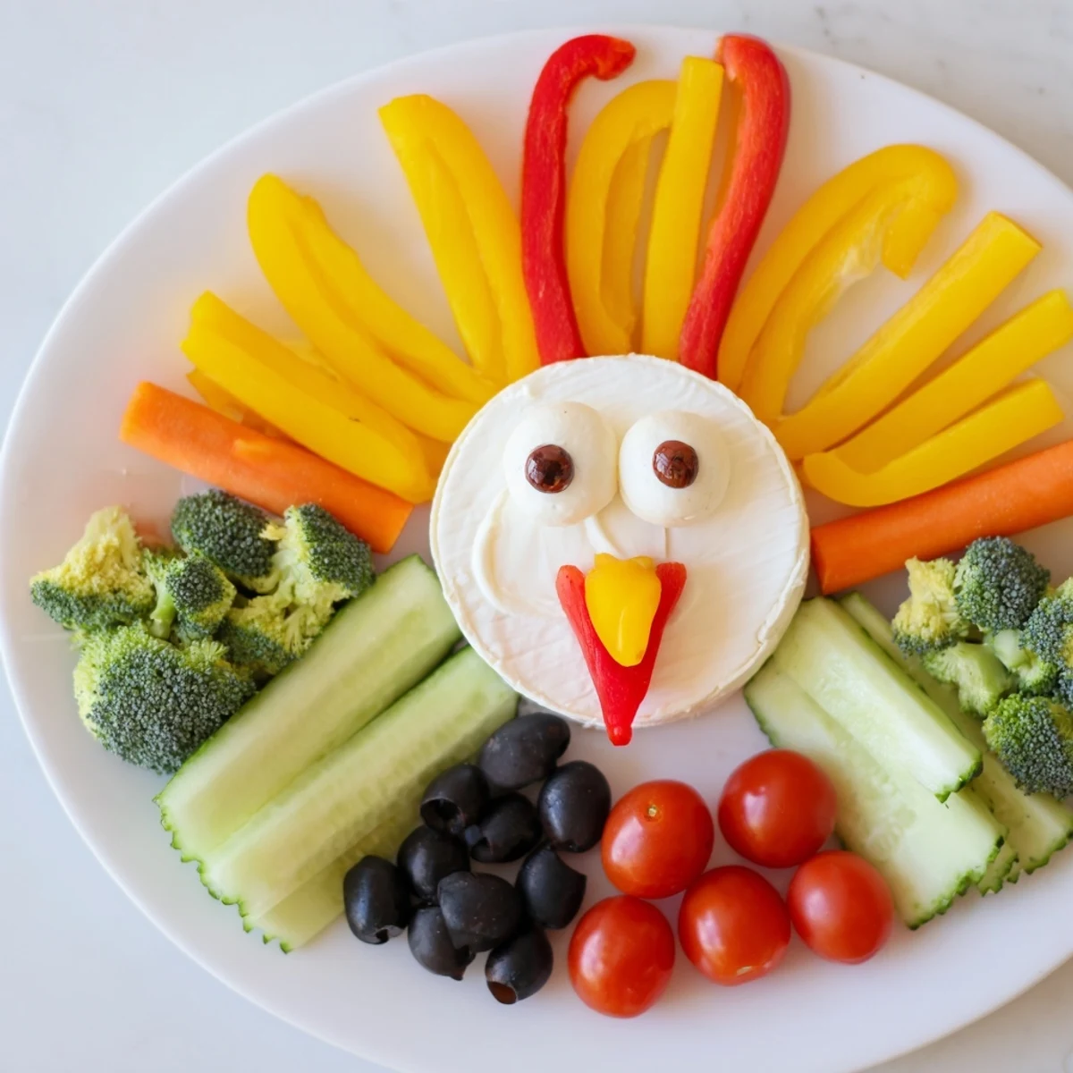 Festive Turkey Shaped Appetizer Tray featuring colorful vegetables, cheeses, and crackers – perfect party food.