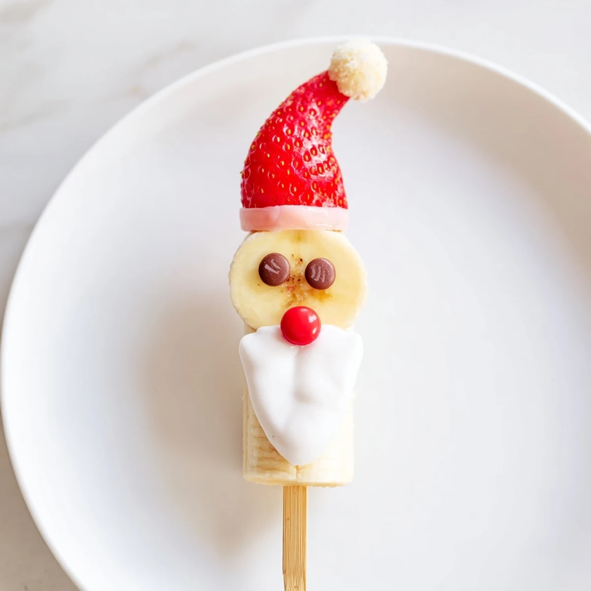 Golden, festive Banana Santa Snack Sticks presented on wooden skewers, ready to be enjoyed as a festive treat.