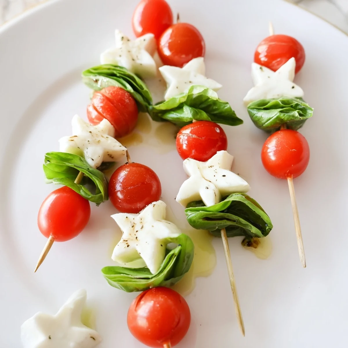 Fresh Caprese skewers arranged with star-shaped mozzarella, tomatoes, and basil, ready to eat.