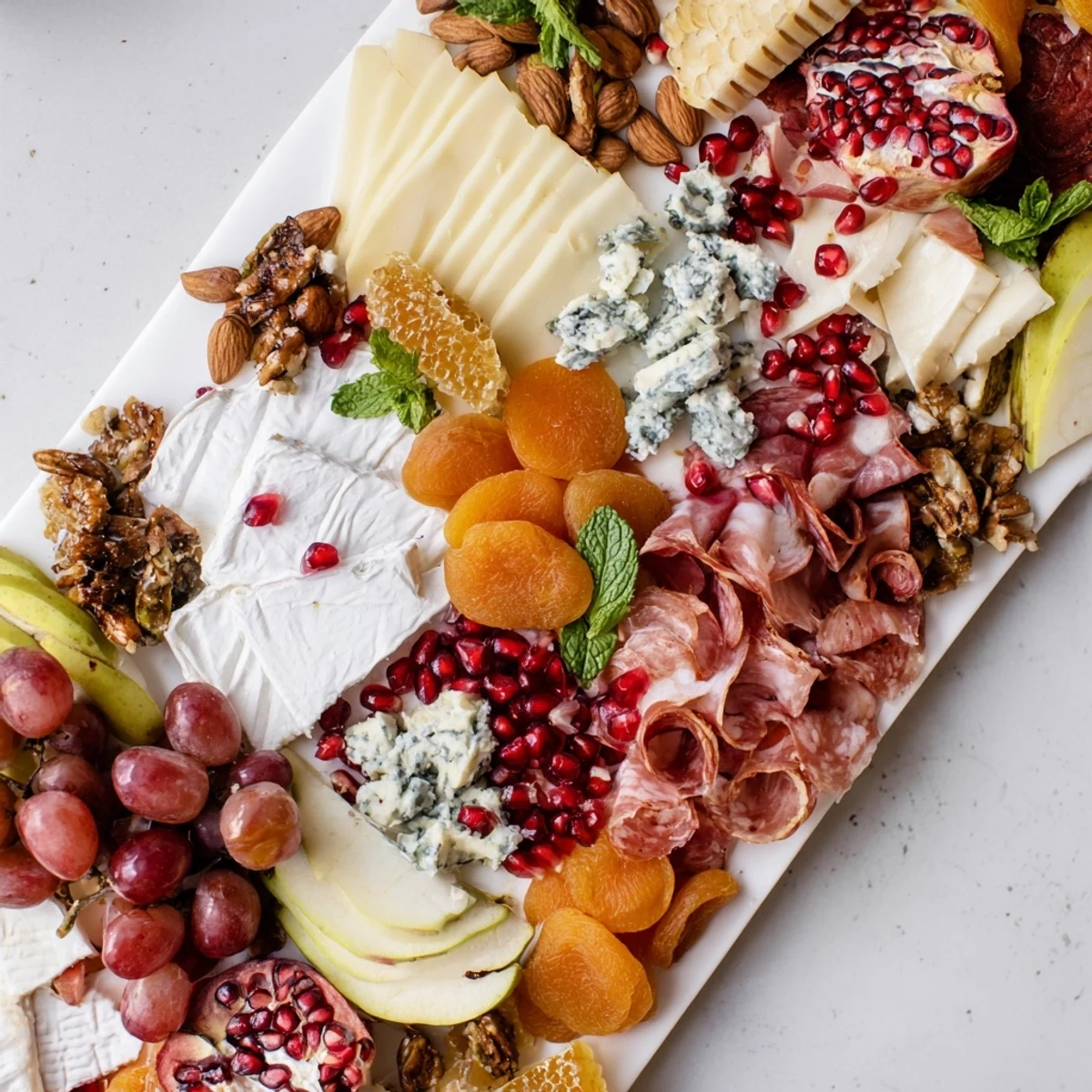 A beautifully arranged Pomegranate Jewel Cascade cheese board, perfect for entertaining with visual delight.