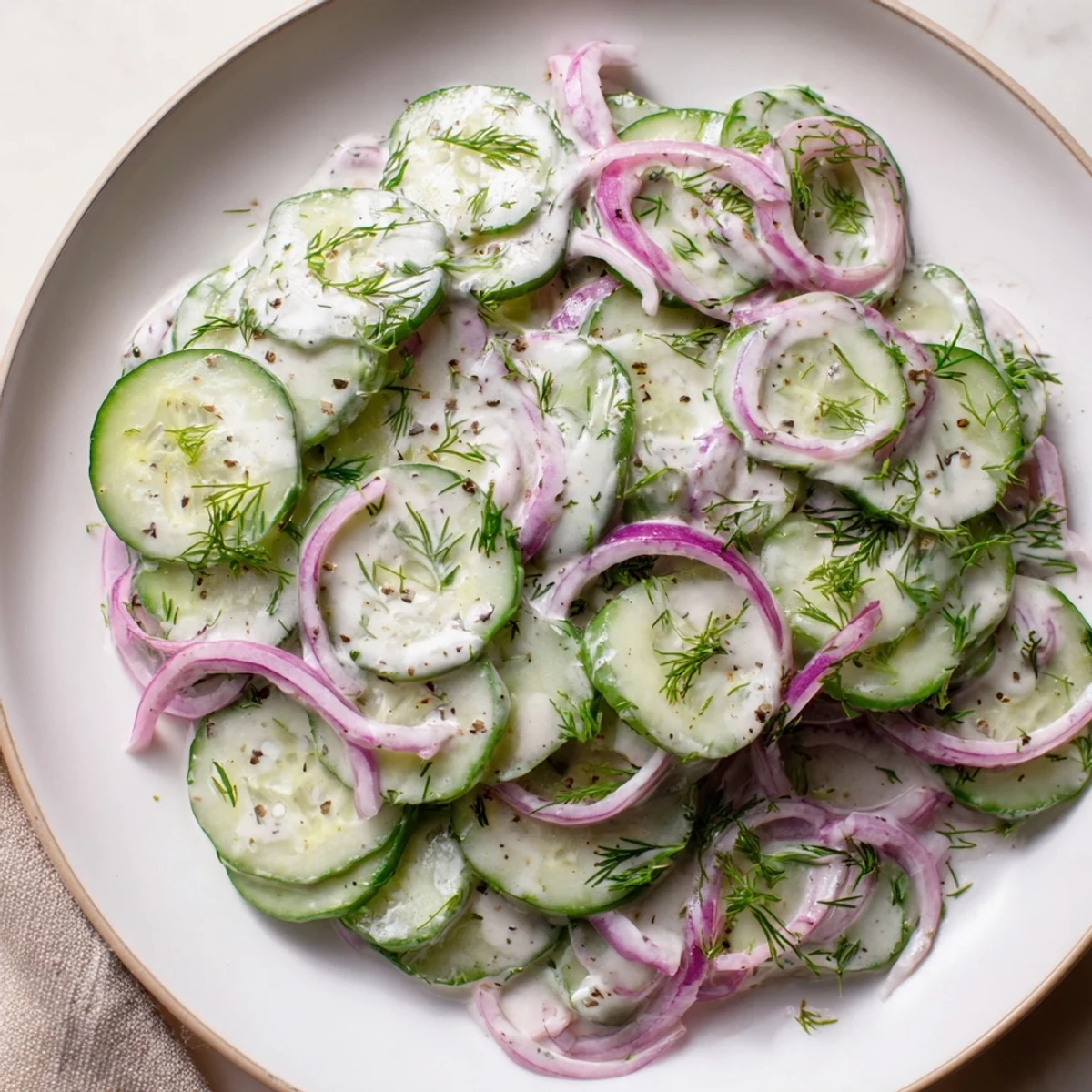 Omas German Cucumber Salad with fresh dill and creamy dressing, perfect side dish visuals.