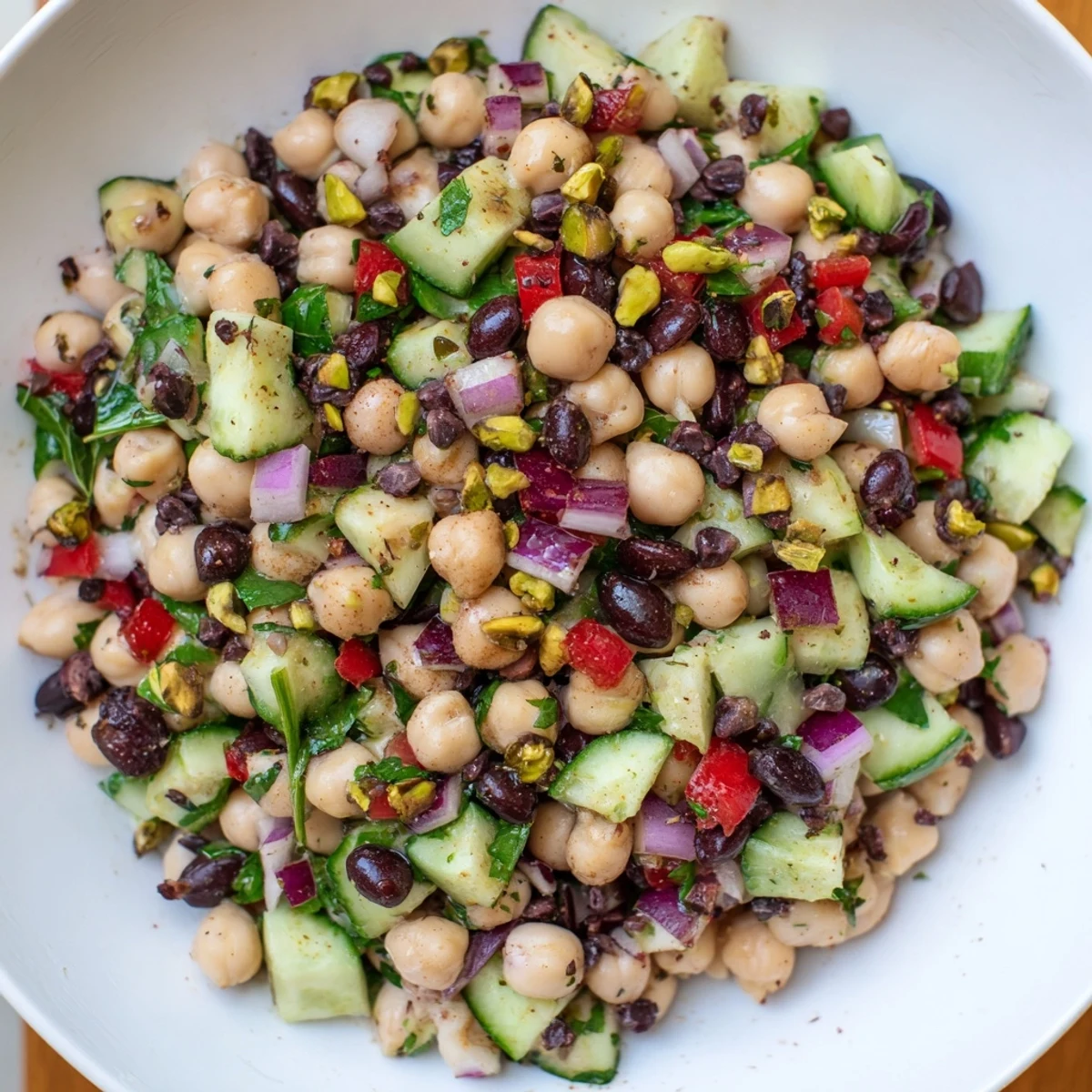 A bowl of the vibrant Dense Bean Salad with Dubai Chocolate Notes, ready to serve.