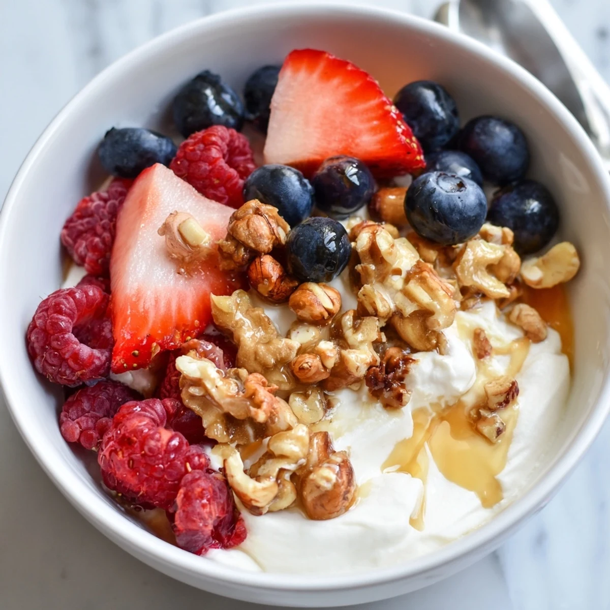 A creamy Cashew Butter Yogurt Parfait with vibrant berries and a drizzle of honey, ready to eat!