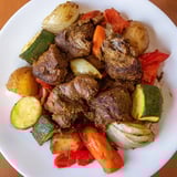Appetizing photo shows a slow-cooked Jordanian Zarb with fall-off-the-bone lamb and veggies.