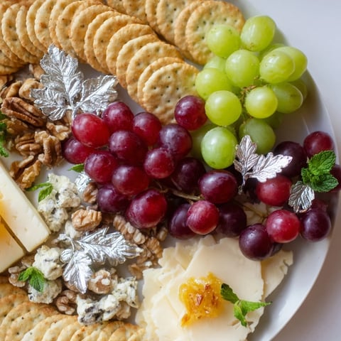 A platter of Sparkling Grape and Silver Crackers showcases glossy grapes and creamy cheeses.