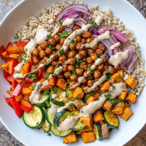 Vibrant Roasted Chickpea Buddha Bowl with crispy chickpeas, tender veggies, and creamy tahini dressing, delicious!