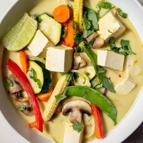 Thai Green Curry Coconut Soup with tender vegetables and fresh herbs, ready for serving.
