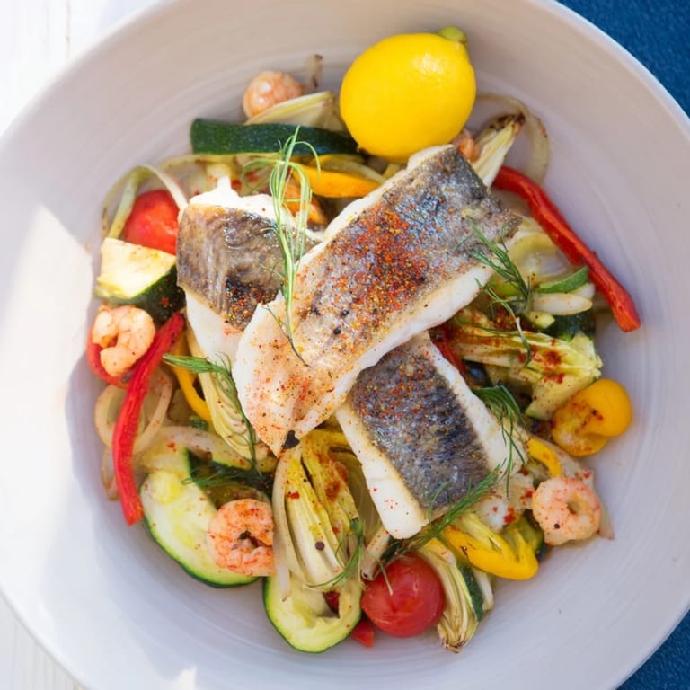 This beautiful Plongeons dans lOcéan Poisson Bleu features a pan of baked fish, shrimp, and fresh herbs.